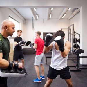 fit-hispanic-man-in-gym-boxing-with-his-trainer--1536x1024