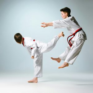 Studio shot of two of kids training karate martial arts